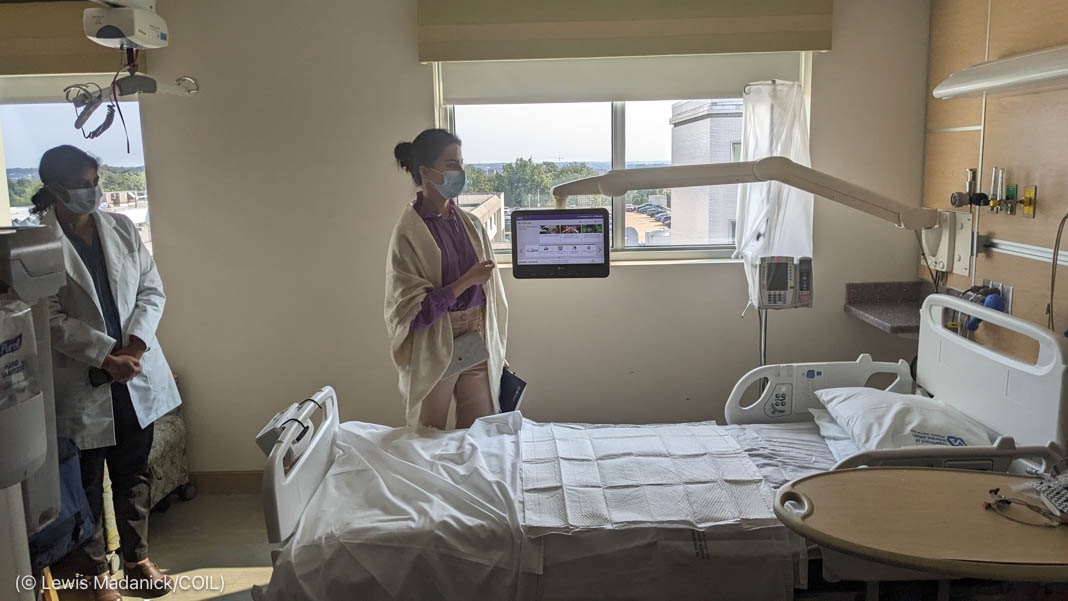 People looking at empty hospital bed (© Lewis Madanick/COIL)